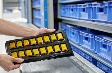 Two hands hlding a tray of lithium polymer batteries